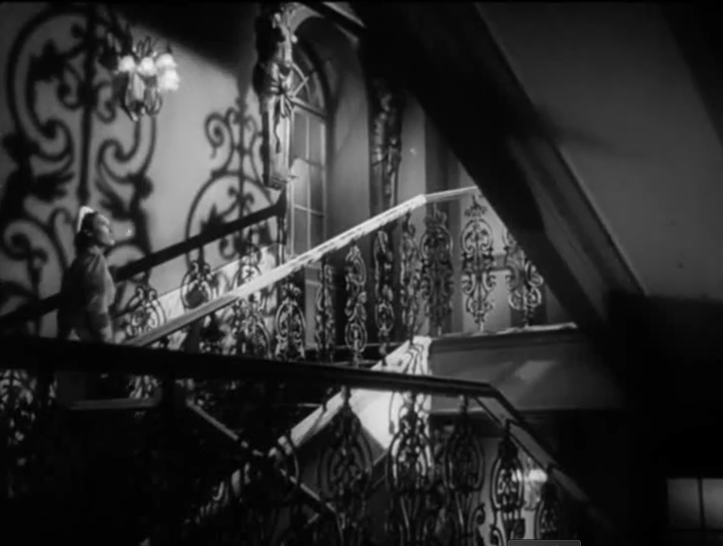 Still from Virginity / Panentsví: Hana walking up the stairs to Councilman Res's apartment